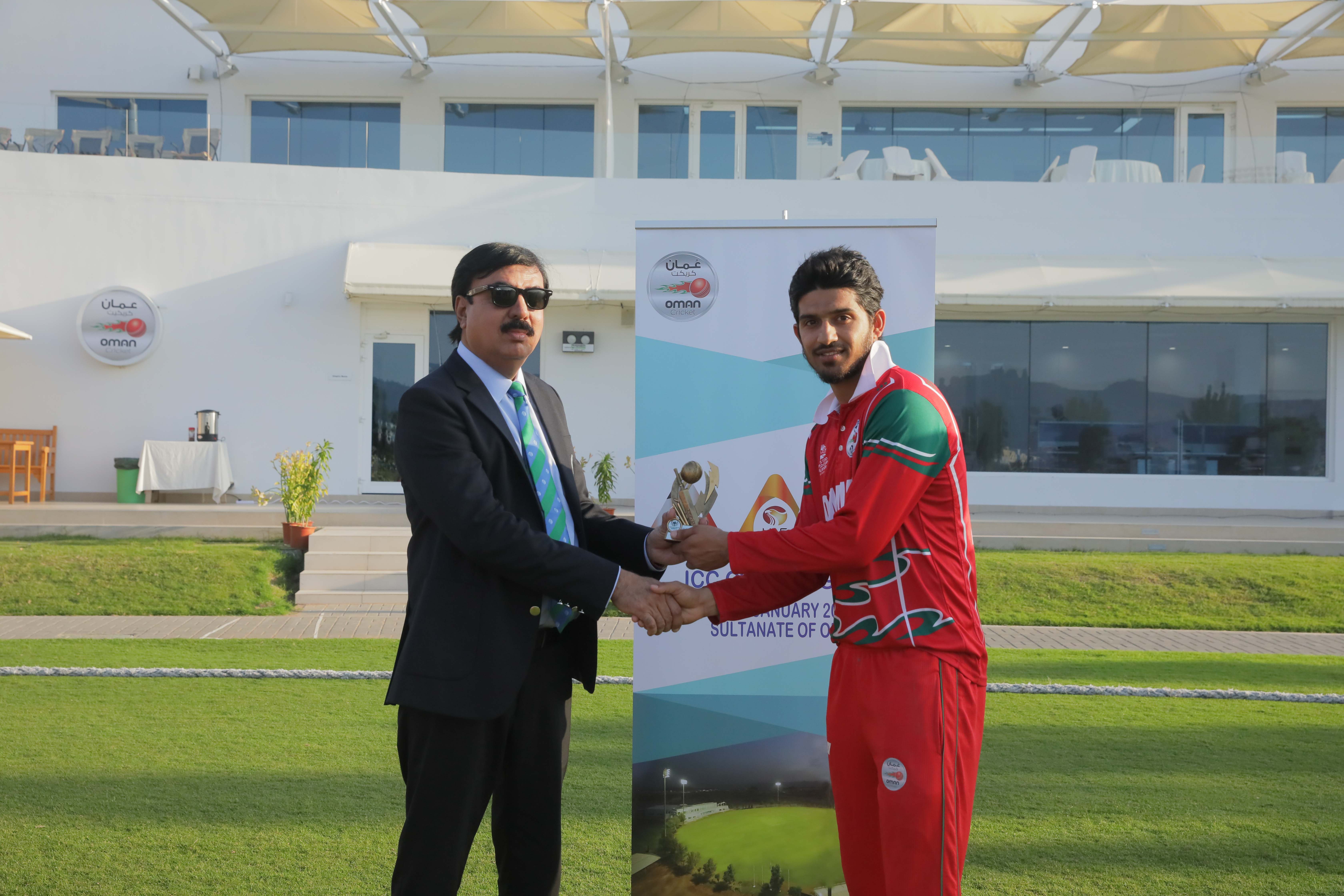 Oman's Aqib Ilyas receiving player of the match award from match referee Mohammed Javed Malik