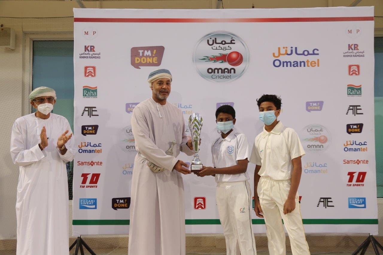 ISM Under-13 captain receiving the winner's trophy