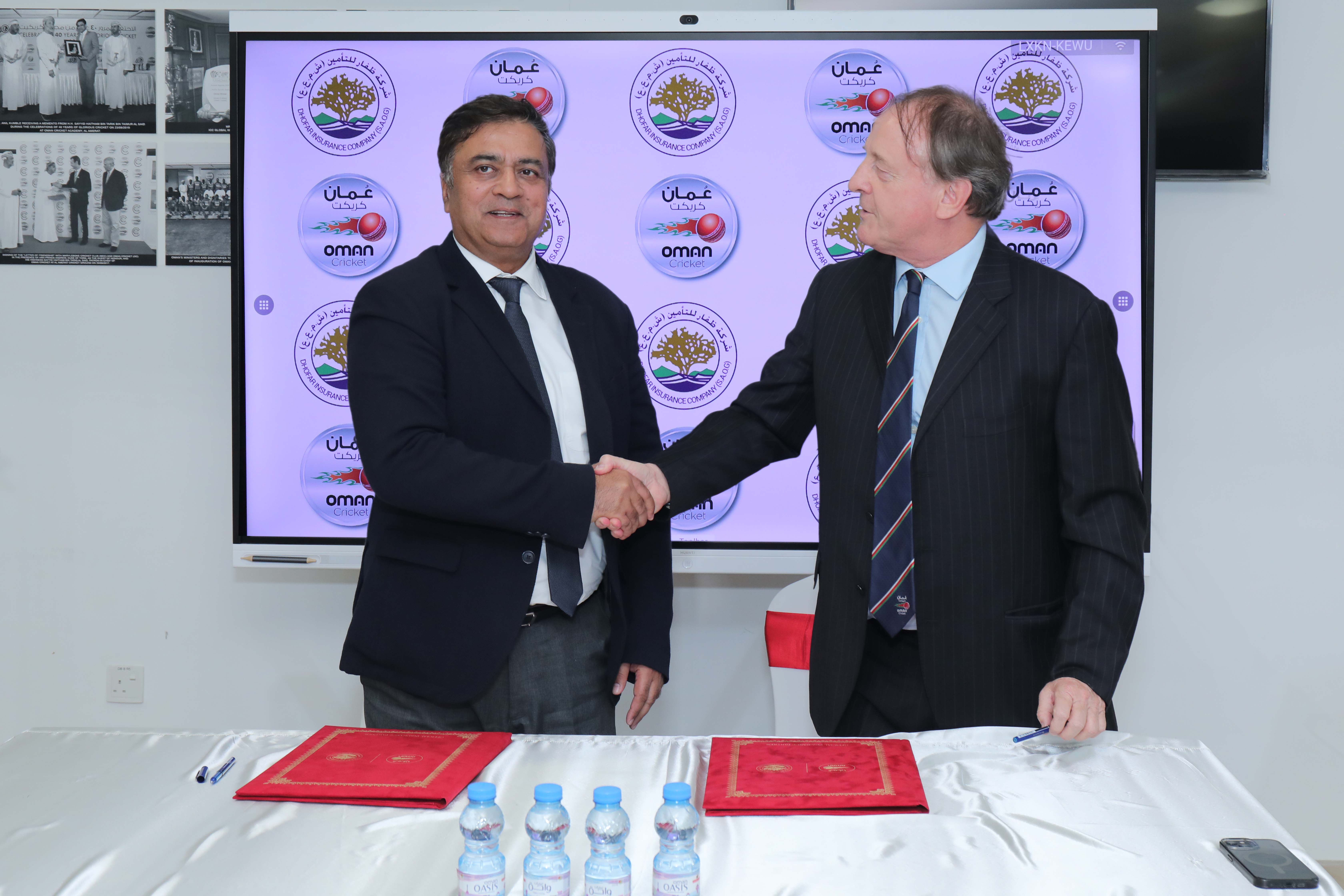 Sunil Kohli (left) shakes hands with Paul Sheridan after signing the agreement